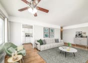 Thumbnail 4 of 27 - a living room with a white couch and a green chair