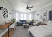 Thumbnail 10 of 24 - a bedroom with a bed and a ceiling fan
