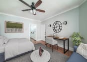 Thumbnail 11 of 24 - a bedroom with a bed and a ceiling fan