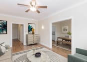 Thumbnail 3 of 22 - a living room with a ceiling fan and a dining room in the background
