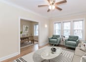 Thumbnail 2 of 22 - a living room with three windows and a ceiling fan