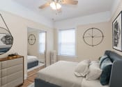 Thumbnail 6 of 22 - a bedroom with a bed and a ceiling fan