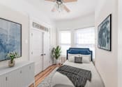 Thumbnail 12 of 38 - a bedroom with a bed and a ceiling fan