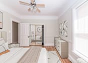 Thumbnail 13 of 38 - a bedroom with a bed and a ceiling fan