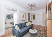 Thumbnail 9 of 38 - a living room with a couch and a coffee table