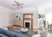 Thumbnail 10 of 38 - a living room with white walls and a blue couch