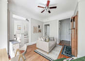 Thumbnail 5 of 38 - a living room with a couch a chair and a ceiling fan