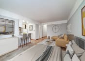 Thumbnail 13 of 37 - a bedroom with a bed sitting next to a living room