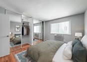 Thumbnail 7 of 28 - a bedroom with a large bed and a large mirror