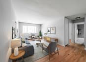 Thumbnail 4 of 28 - a living room with white walls and hardwood floors