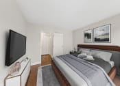 Thumbnail 21 of 62 - a bedroom with a bed and a tv on the wall