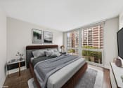Thumbnail 22 of 62 - a bedroom with a large bed and a large window