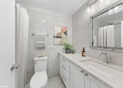 Thumbnail 24 of 62 - a bathroom with a sink toilet and a mirror