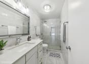 Thumbnail 12 of 62 - a white bathroom with a shower and a sink
