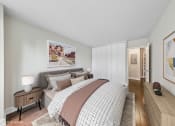 Thumbnail 14 of 62 - a bedroom with white walls and a bed with pillows