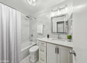 Thumbnail 15 of 62 - a white bathroom with a shower toilet and sink