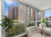 Thumbnail 5 of 62 - a living room with large windows and a view of the city