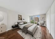 Thumbnail 10 of 62 - a bedroom with a bed and a large window