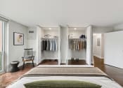 Thumbnail 11 of 62 - a bedroom with a bed and a closet with closet doors