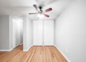 Thumbnail 20 of 28 - a bedroom with two closets and a ceiling fan