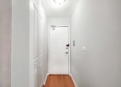 Thumbnail 15 of 28 - a bedroom with a medium sized bed and a white door
