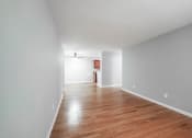 Thumbnail 18 of 28 - a bedroom with gray walls and a hardwood floor