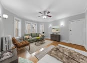 Thumbnail 4 of 24 - a living room with a couch and a ceiling fan
