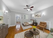Thumbnail 6 of 24 - a living room with a couch and a ceiling fan