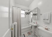 Thumbnail 9 of 24 - a white bathroom with a shower and a sink