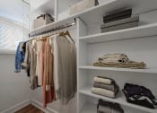 Thumbnail 10 of 31 - a closet with shelves and shelves of clothes and folded towels