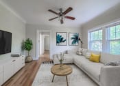 Thumbnail 2 of 31 - a living room with a couch and a ceiling fan