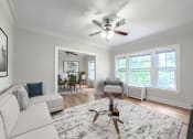 Thumbnail 3 of 31 - a living room with a couch and a ceiling fan