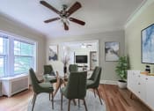 Thumbnail 5 of 31 - a dining room with a table and chairs and a ceiling fan