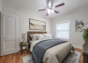Thumbnail 8 of 31 - a bedroom with a bed and a ceiling fan