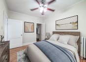 Thumbnail 9 of 31 - a bedroom with a bed and a ceiling fan