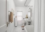 Thumbnail 11 of 31 - a white bathroom with a sink toilet and tub