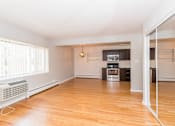Thumbnail 13 of 28 - a living room with hardwood floors and a large window