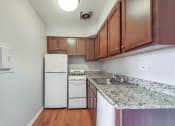 Thumbnail 12 of 28 - a kitchen with white appliances and granite countertops