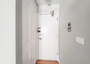 Thumbnail 9 of 28 - a white door in a room with a wooden floor and grey walls