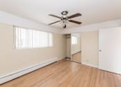 Thumbnail 22 of 28 - a bedroom with hardwood floors and a ceiling fan