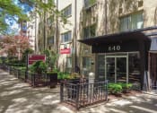 Thumbnail 1 of 28 - an apartment building with a large entrance and a sign that says 6410