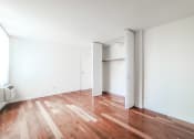 Thumbnail 13 of 43 - a bedroom with hardwood floors and white walls
