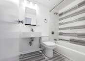 Thumbnail 23 of 43 - a bathroom with a sink toilet and bathtub