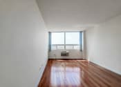 Thumbnail 22 of 43 - an empty room with white walls and a large window with blue shutters