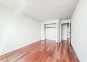 Thumbnail 21 of 43 - a bedroom with hardwood floors and white walls