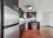 Thumbnail 17 of 43 - a kitchen with dark wood cabinets and stainless steel appliances