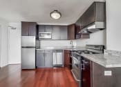 Thumbnail 16 of 43 - a kitchen with stainless steel appliances and granite countertops