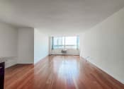 Thumbnail 19 of 43 - a bedroom with hardwood floors and white walls