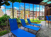 Thumbnail 41 of 51 - Two blue lounge chairs are placed on a patio.