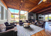 Thumbnail 48 of 51 - A living room with brown leather chairs and a wooden ceiling.